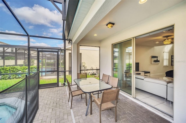 sunroom with ceiling fan and a healthy amount of sunlight