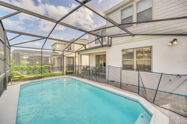 2468 Dubai St, Kissimmee, FL 34747 - outdoor pool featuring glass enclosure and a patio
