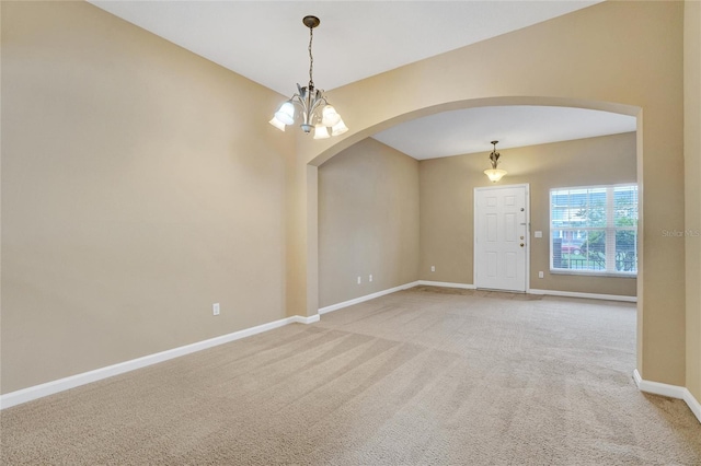 unfurnished room featuring carpet flooring and an inviting chandelier