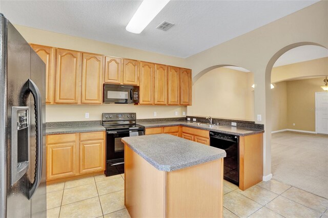 kitchen featuring a center island, sink, a textured ceiling, light tile patterned floors, and black appliances