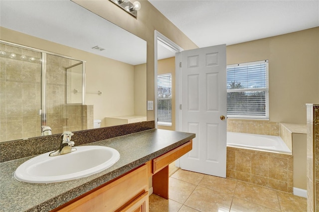 bathroom featuring tile patterned floors, vanity, separate shower and tub, and a healthy amount of sunlight