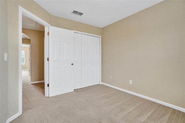 unfurnished bedroom featuring carpet flooring and a closet