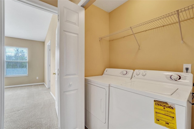 clothes washing area with washing machine and dryer and light carpet