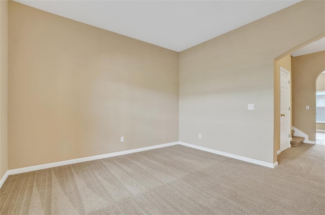 unfurnished room featuring light carpet