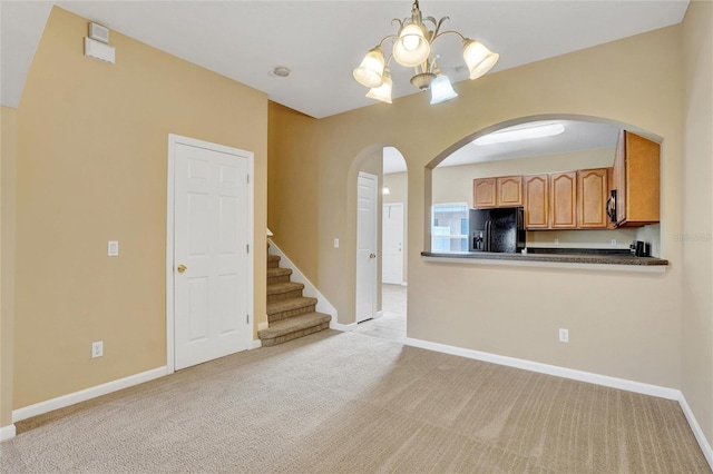 interior space featuring a chandelier and light colored carpet