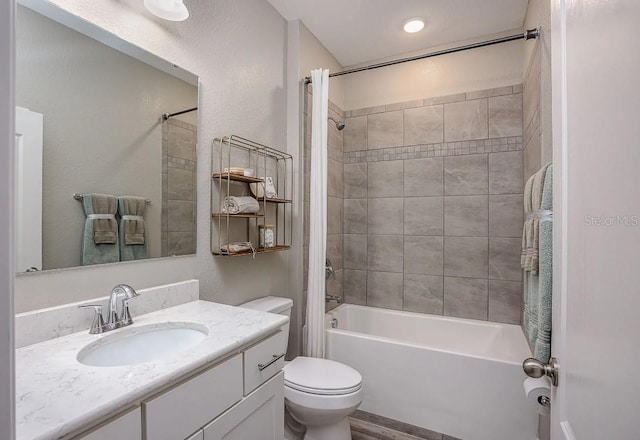 full bathroom with tiled shower / bath combo, toilet, and vanity