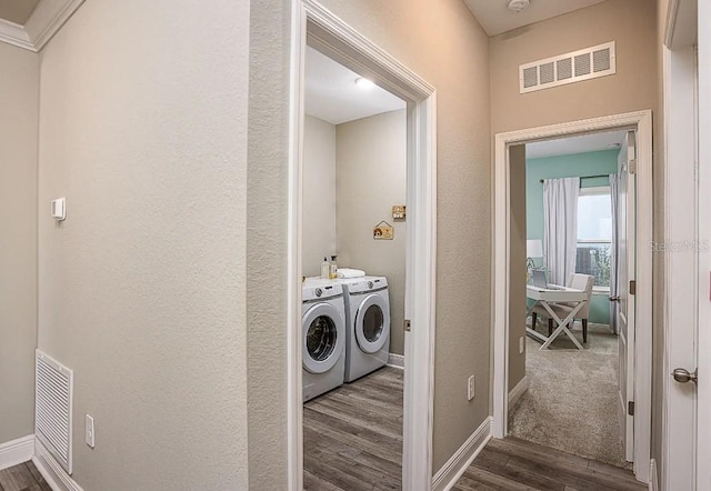 laundry room with dark hardwood / wood-style floors and separate washer and dryer