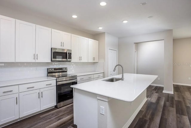 kitchen with a kitchen island with sink, sink, white cabinets, and stainless steel appliances