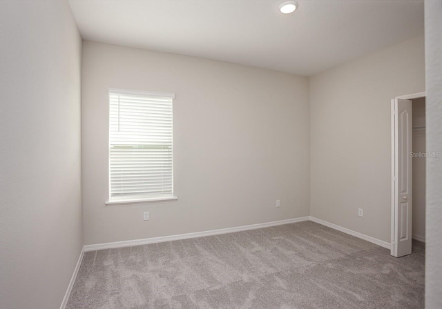 unfurnished bedroom featuring light carpet