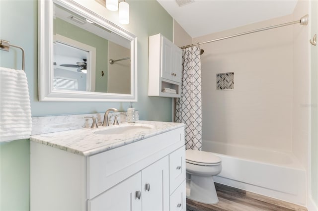 full bathroom with shower / tub combo, vanity, ceiling fan, wood-type flooring, and toilet