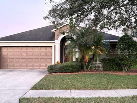 ranch-style home featuring a garage