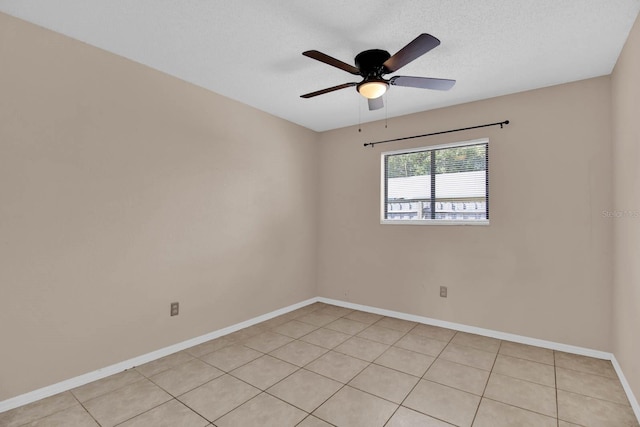 tiled spare room featuring a textured ceiling and ceiling fan