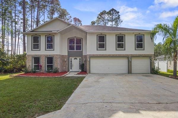 view of front of house featuring a garage and a front lawn