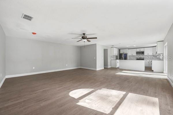 unfurnished living room with ceiling fan and dark hardwood / wood-style floors