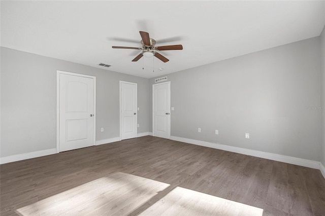 unfurnished bedroom featuring dark hardwood / wood-style floors and ceiling fan