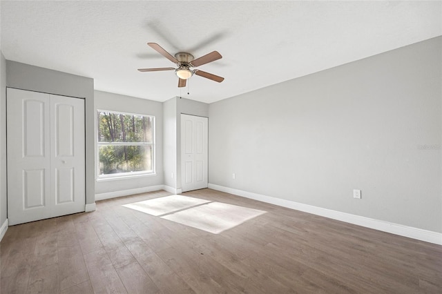 unfurnished bedroom featuring hardwood / wood-style flooring and ceiling fan