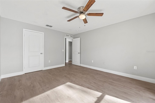 unfurnished bedroom featuring hardwood / wood-style flooring and ceiling fan