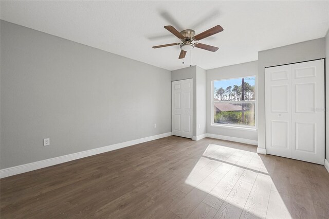 unfurnished bedroom with ceiling fan and wood-type flooring