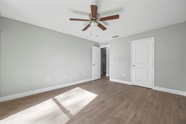 unfurnished bedroom with ceiling fan and hardwood / wood-style floors