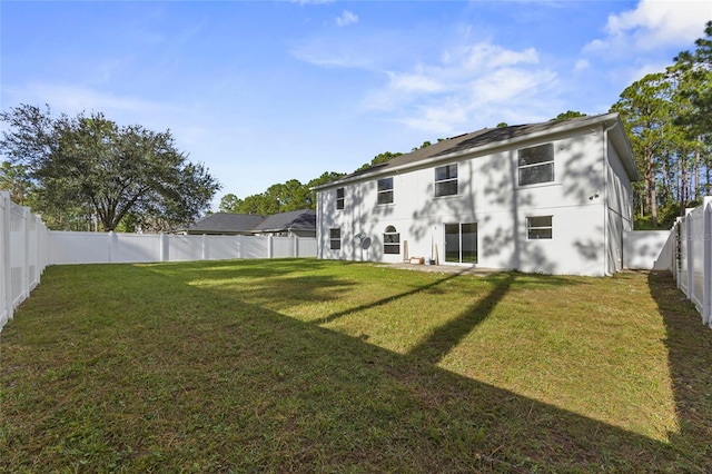 back of house with a lawn