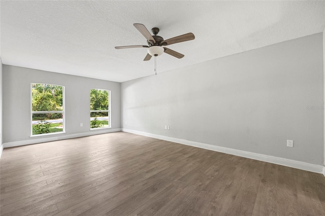 spare room featuring ceiling fan, dark hardwood / wood-style flooring, and a textured ceiling