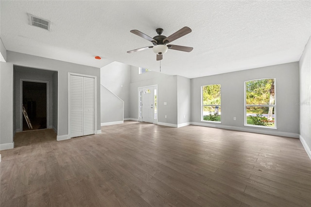 unfurnished living room with hardwood / wood-style floors, a textured ceiling, and ceiling fan