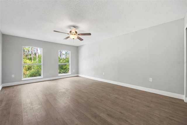 unfurnished room featuring a textured ceiling, ceiling fan, and dark wood-type flooring