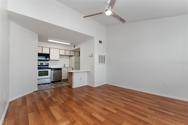 kitchen featuring white cabinets, light wood-type flooring, stainless steel appliances, and ceiling fan