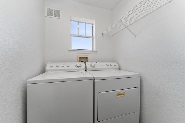 washroom with independent washer and dryer