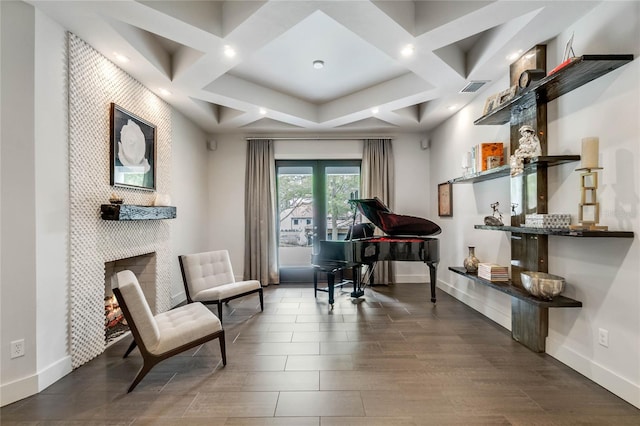 living area featuring beamed ceiling, dark hardwood / wood-style flooring, and coffered ceiling