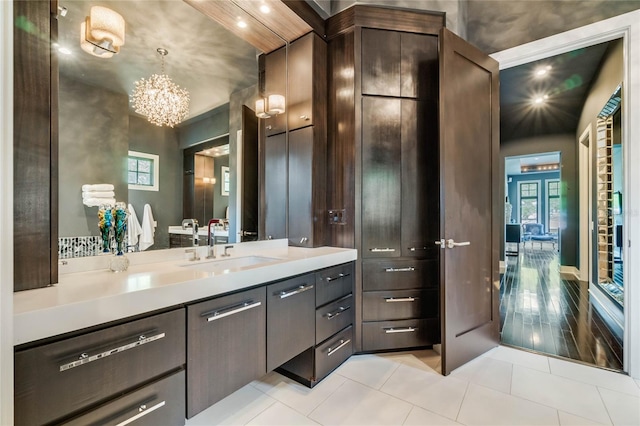 bathroom featuring vanity, hardwood / wood-style flooring, and a notable chandelier