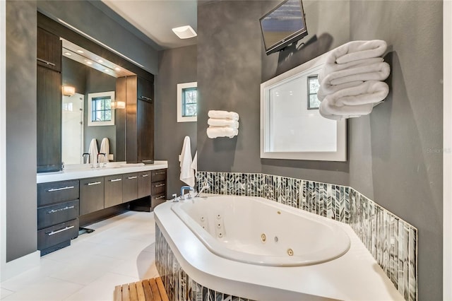 bathroom featuring a washtub, vanity, and tile patterned flooring