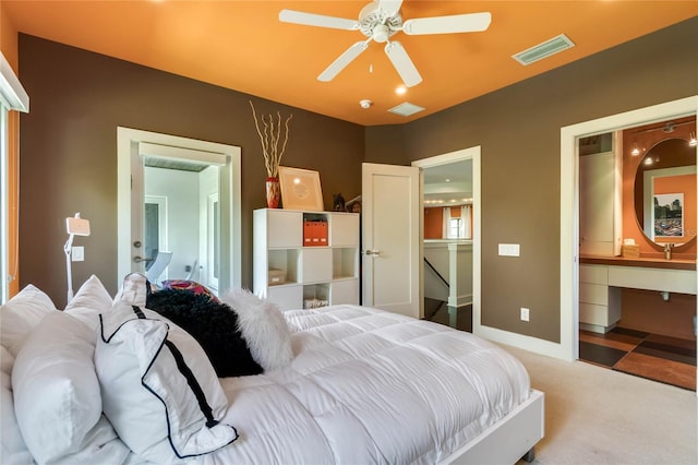 bedroom with connected bathroom, ceiling fan, and carpet floors