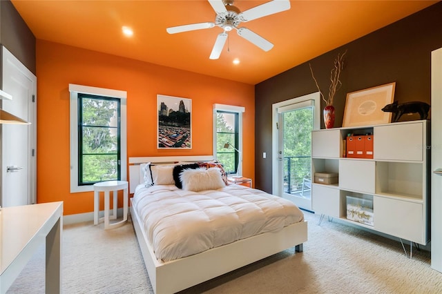 bedroom featuring ceiling fan, access to exterior, light carpet, and multiple windows