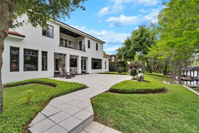 view of yard with a balcony and a patio area