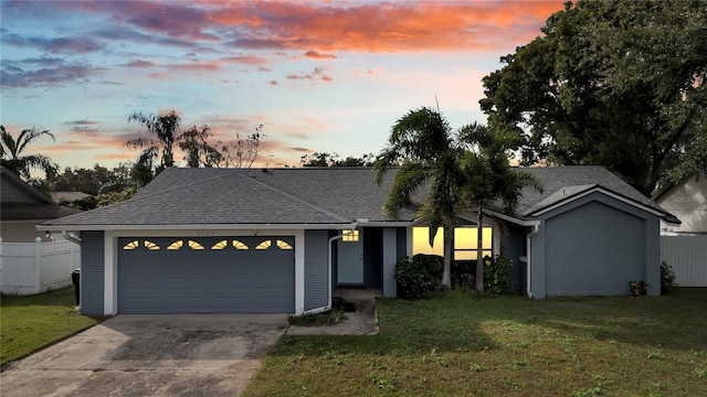 view of front facade with a lawn and a garage