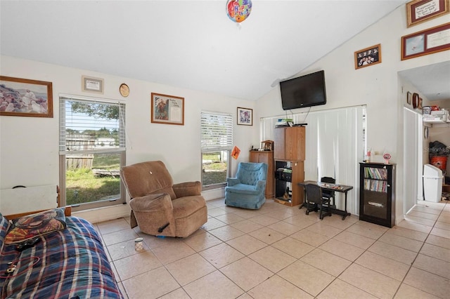 tiled living room featuring vaulted ceiling and a healthy amount of sunlight