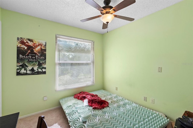 bedroom with carpet, a textured ceiling, and ceiling fan