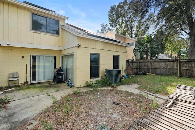 rear view of property featuring central AC