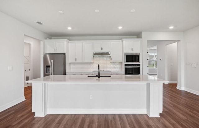 kitchen featuring backsplash, a spacious island, dark hardwood / wood-style flooring, white cabinetry, and stainless steel appliances