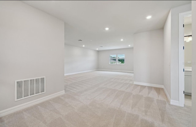 unfurnished room with light carpet