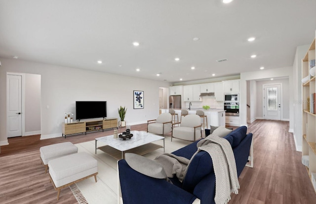 living room with light hardwood / wood-style flooring