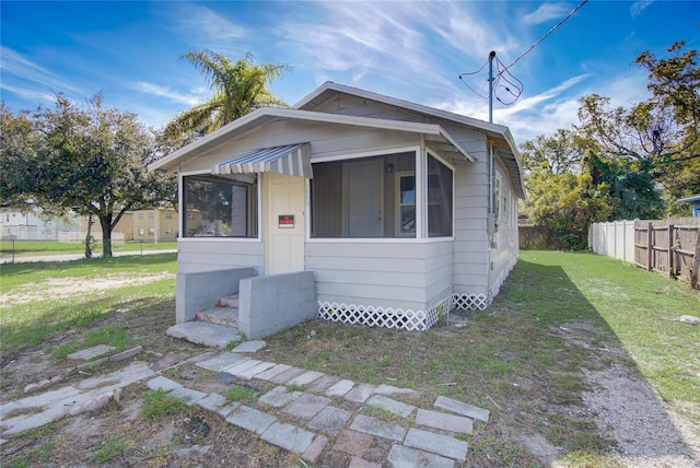 bungalow-style home with a front lawn