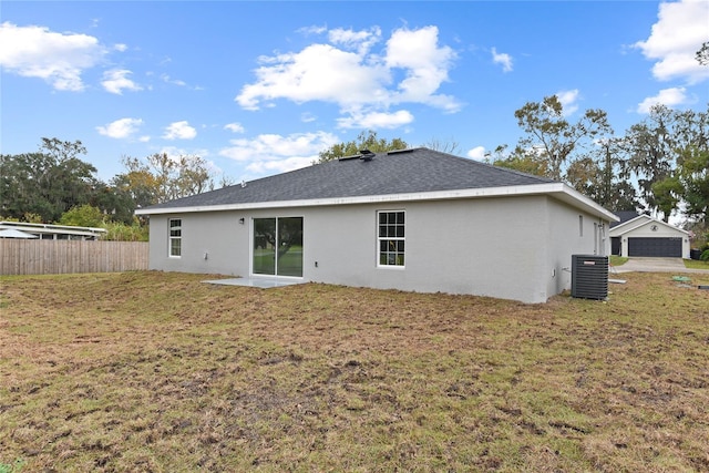 back of property featuring a yard and central air condition unit