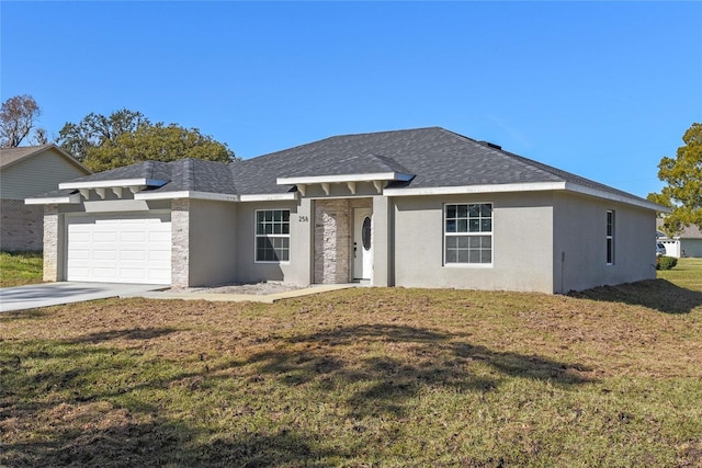 view of front of property featuring a garage and a front lawn