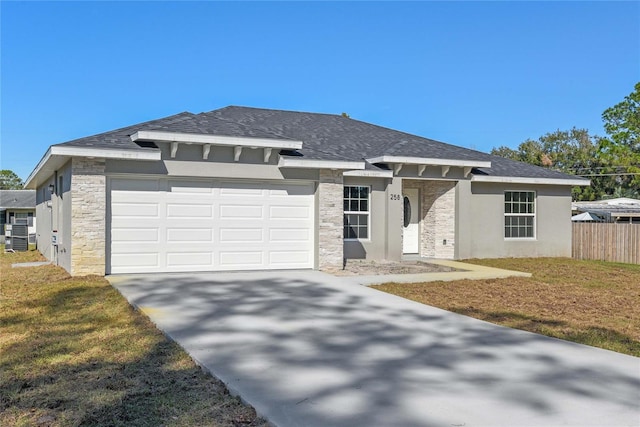 view of front of property with a garage and a front yard