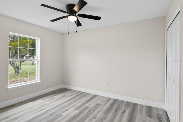 empty room with ceiling fan and light hardwood / wood-style floors