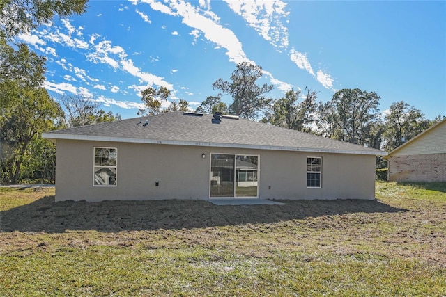 back of house with a lawn