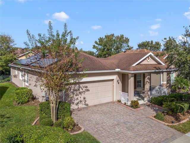 ranch-style home with a garage and covered porch