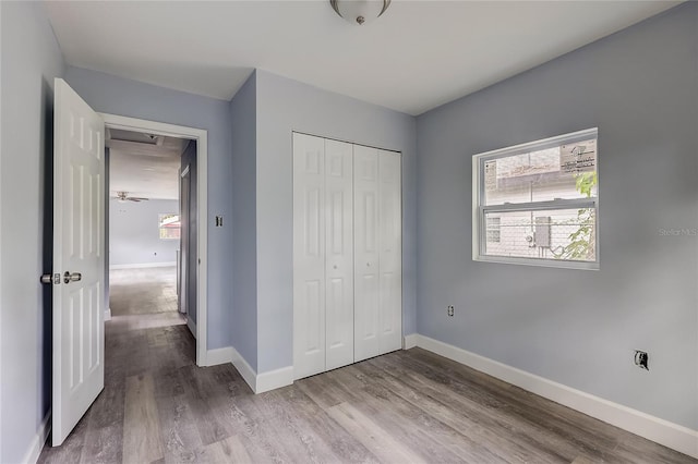 unfurnished bedroom with a closet and hardwood / wood-style floors